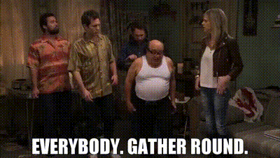 Gif of a scene from It's Always Sunny In Philadelphia with Frank stepping away from the group and mouthing 'Everybody. Gather round.'